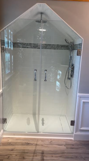 Frameless glass shower enclosure