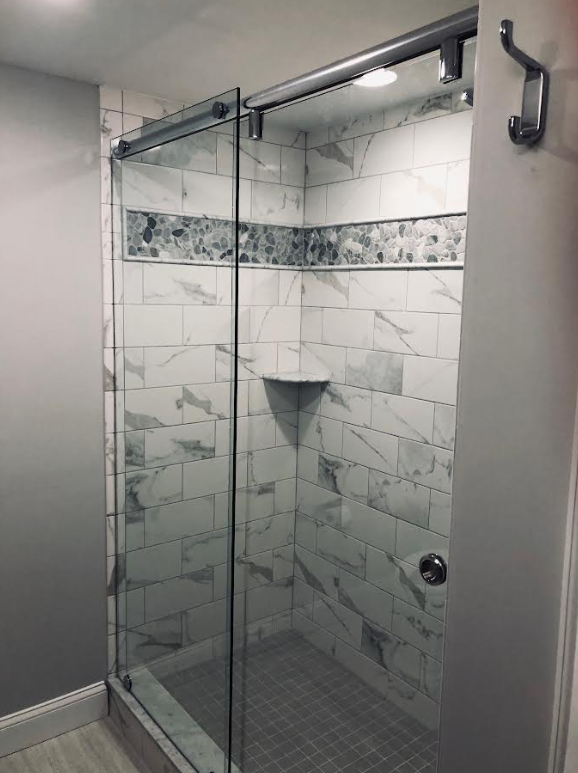 Frameless shower door with barn door hardware