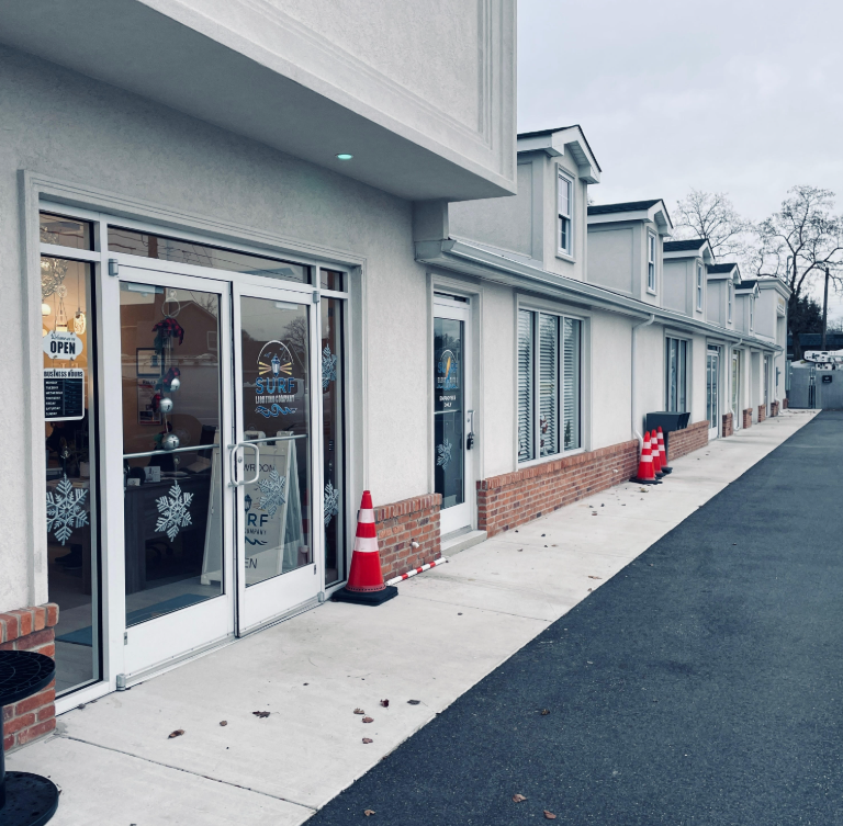 Commercial storefront glass installation with white aluminum framing